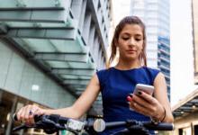 cyclist stopped to check her mobile device